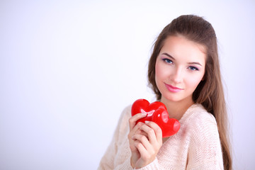 Beautiful woman hold red hear, isolated on gray background