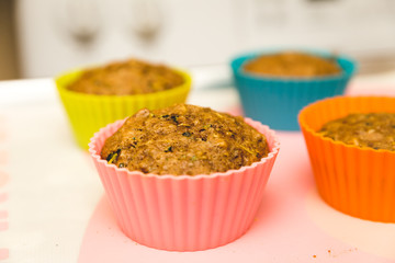 Multi-grain muffins in colorful silicone cups.