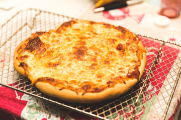 Freshly Baked Pizza Cooling on a Metal Rack