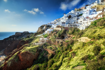 Naklejka premium Classical view from sunset point at Oia village white and blue architecture, Santorini island, Greece. Incredible evening scenery.