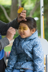 DALLAS, TEXAS - APRIL 22, 2017: Face painting service in Japanese Garden Spring Festival at Fort Worth Botanic Garden