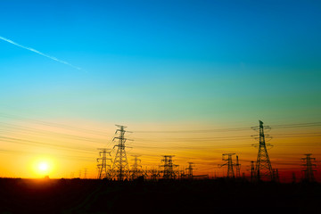 High voltage towers, under the setting sun