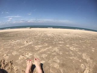 feet in the sand on lake michigan