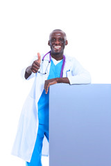 Portrait of doctor showing you ok sign standing in a white uniform on isolated background
