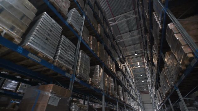 Logistics business and shipping facility with forklifts to move boxes and parcels. cardboard boxes inside a storage warehouse