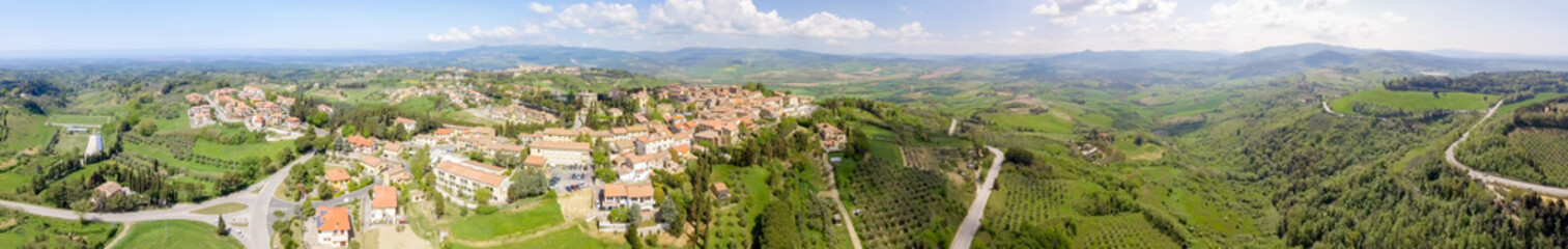 Fototapeta na wymiar Tuscany countryside and medieval town on the hill. Amazing panoramic aerial view