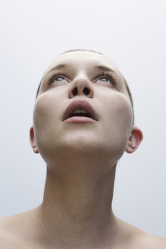 Surprised Caucasian woman with shaved-head looking up