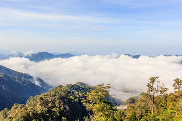 Morning fog in the mountains early in blue sky, mountains and forest. Landscape of chin swee cave temple, Ipoh, Malaysia.