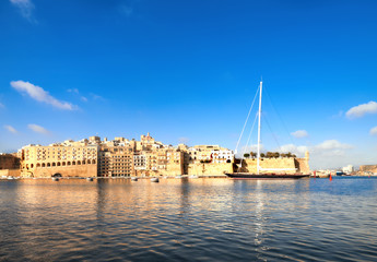 Fototapeta na wymiar Sailing ship enters Grand Valetta Bay, Malta