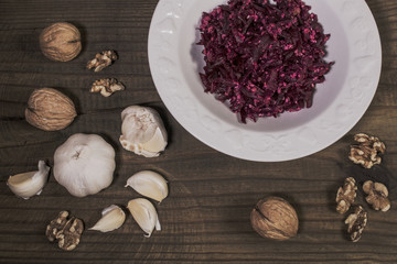 Grated beet salad with garlic and waltuts