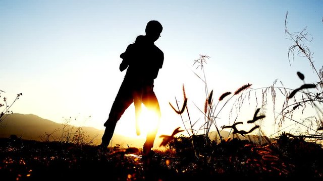 Father and daughter spinning cast around in flare sunrise