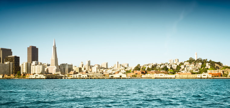 San Francisco skyline and waterfront panorama including iconic buildings. Intentionally bleached and tinted with a retro color palette. Copy space.