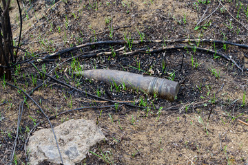 Old unexploded artillery shell  on the ground.