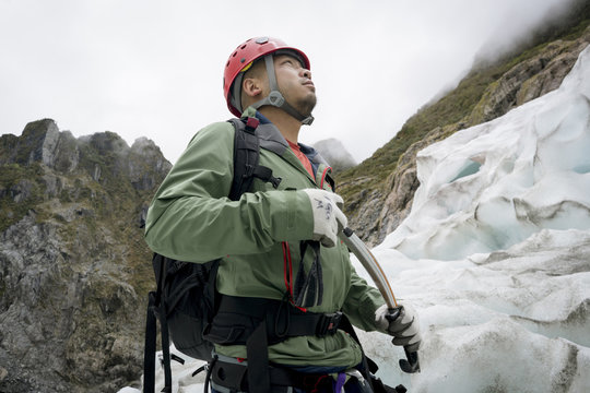 Man looking up at glacier outdoors