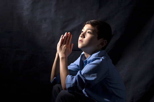 Young boy in prayer.