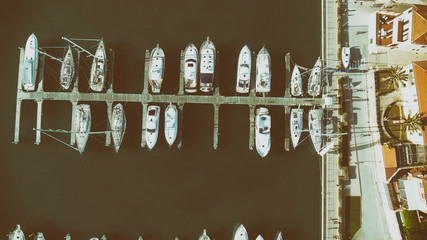 Overhead aerial view of anchored boats in a small port
