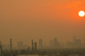 Oil refinery in metropolis on sunset.