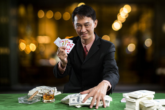  The player gather the piles of banknote when the points over rival on green table