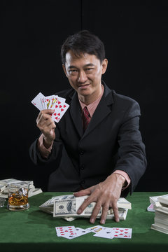The player gather the bets and show the points over rival on green table