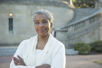 Portrait of Black woman posing near stone staircase
