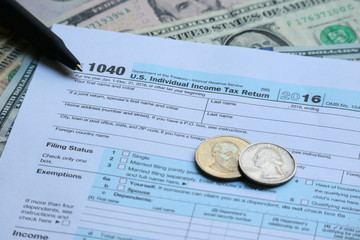 Tax form with dollar cash and pen, tax season and accounting concept