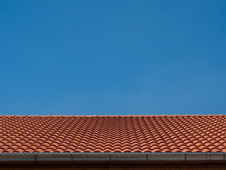 red tile rooftop on blue sky background