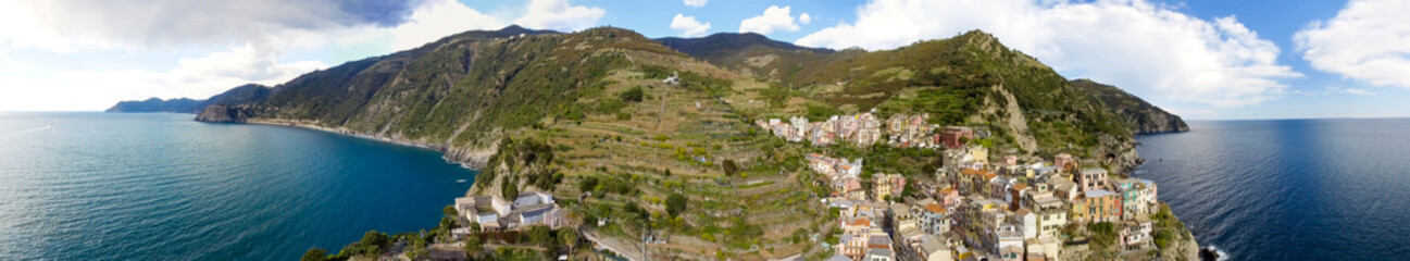 Manarola aerial panoramic view from helicopter. Five Lands with cloudy sky