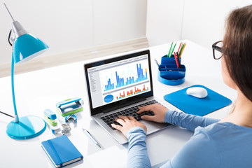 Businesswoman Looking At Graph On Laptop