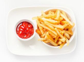 French fries served with tomato sauce on white plate.
