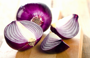 Fresh red onions on   wooden board