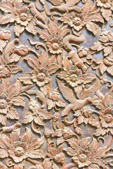 wooden carved bird and flowers used for background, vertical background