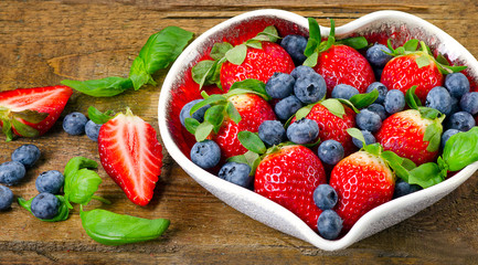 Berries in heart shaped bowl.
