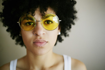 Portrait of young woman wearing yellow sunglasses