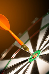 red darts hitting the center of target on black background