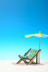 Sunbed at the beach on background of blue sky