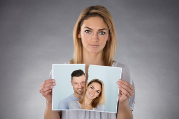 Woman Holding Torn Photo