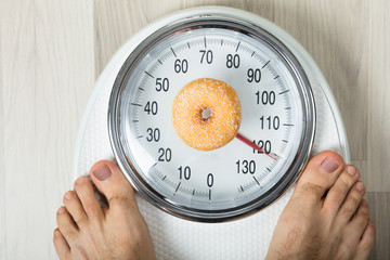 Donut And A Person On Weighing Scale