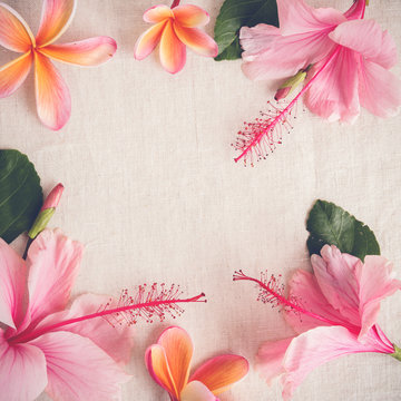 Pink and orange summer flowers on linen copy space background