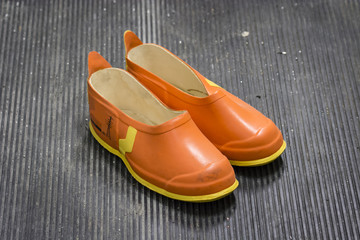 Protective insulating shoes in the substation.