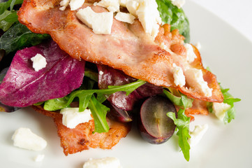 mix leafs and brisket pork salad with black grapes, bryndza dressed with olive oil, lemon juice, and finely chopped garlic 