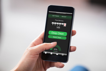 Person Cleaning Smart Phone Memory
