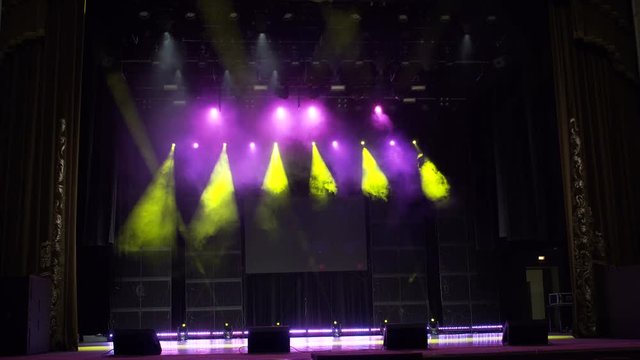 Spotlight, a few points of light on stage. Blurred lights a rock concert. 4k