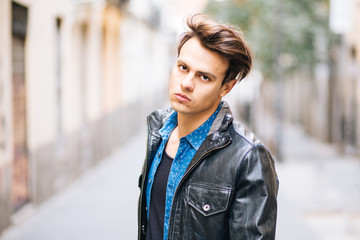 Confident and handsome young man in the street