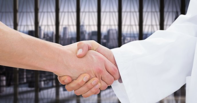 Doctor shaking hand with patient in clinic
