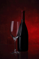 Wineglass and bottle with red wine