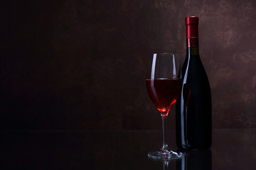 Fototapeta na wymiar Wineglass and bottle with red wine