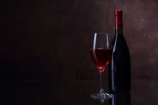 Wineglass and bottle with red wine