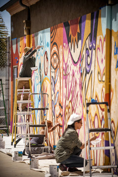 People painting on wall