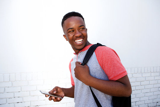 Smiling College Student Walking With Bag And Mobile Phone