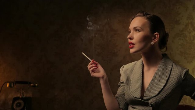 Beautiful woman smoking cigarette in retro interior